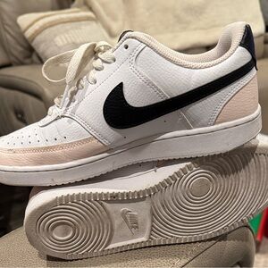 Nike Dunk Low in pink black and white. See all photos